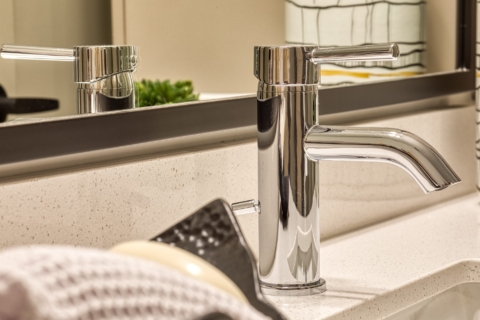 Close up photo detail of chrome bathroom faucet